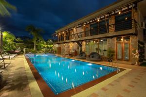 曼德勒Mandalay Lodge Hotel的夜间带游泳池的别墅