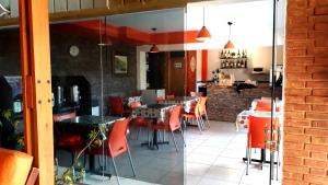 圣拉斐尔弗朗西亚酒店的餐厅内带橙色椅子和桌子的用餐室