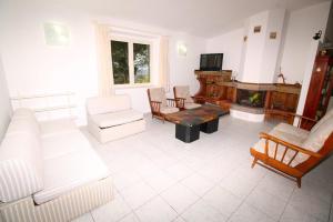 多尔加利Villa Badde rosa的客厅配有白色家具和壁炉