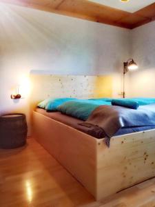 RossleithenApartment Vorderstoder的一间卧室配有一张大木床和蓝色床单