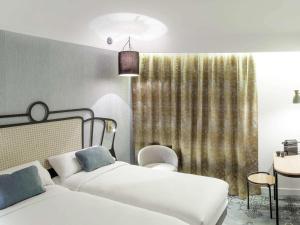 埃尔顿奥尔良港索隆美居酒店 的一间卧室设有两张床和窗户。