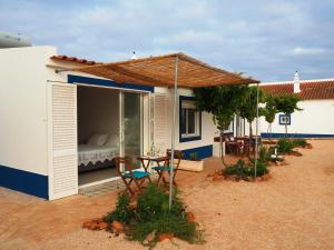 拉戈斯Quinta do Maranhão的房屋设有1个带1张床和1把遮阳伞的庭院