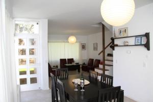 皮纳马尔Complejo Tridente的用餐室以及带桌椅的起居室。