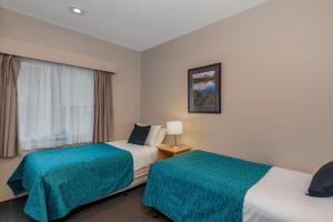 霍巴特湾景别墅的酒店客房设有两张床和窗户。