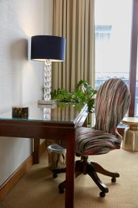 伦敦仕骅廷骑士桥酒店公寓的客房配有桌椅和台灯