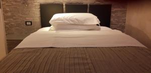 福贾A 2 PASSI da的一张带白色床单和枕头的床