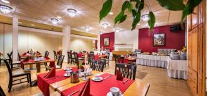 特里尔斯塔德特沃德酒店的一间设有红色桌椅的餐厅以及一间自助餐
