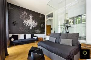 都灵Boutique Apartment Glamour Torino的带沙发和吊灯的客厅