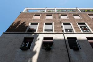 罗马Guest House Al Conservatorio的一座高大的砖砌建筑,设有窗户,天空蔚蓝