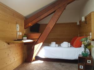 里雾诗坎巴努乐酒店的卧室配有一张床铺,位于带木墙的房间内