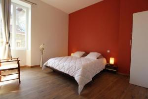 ChâteaubourgAppartement Spacieux et confortable的一间卧室设有一张床和红色的墙壁