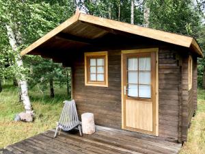 黑德梅埃斯泰Suurkivi Nature Escape的小木屋设有长凳和门