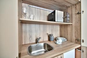 KirkopThe Suites – Piazza Kirkop的厨房配有水槽和微波炉