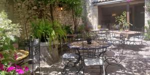 卢河畔拉科尔卡莱斯住宿加早餐旅馆的一个带桌椅和植物的庭院