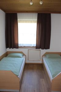 Lungötz卡夫公寓的带窗户的客房内的两张床
