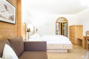 施伦斯阿卡缇弗阿尔彭罗斯温泉酒店的一间卧室配有一张床和镜子
