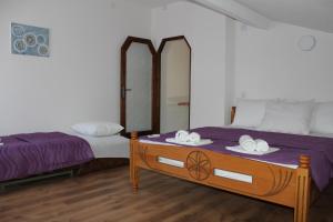 奥赫里德Petroski Apartments的一间卧室配有两张床和一张带两面镜子的桌子。