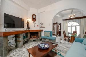 纳克索乔拉Naxos Center Houses的客厅设有壁炉和电视。