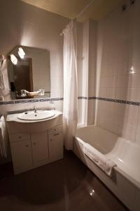 O Pino 贝洛酒店的一间带水槽、浴缸和淋浴的浴室