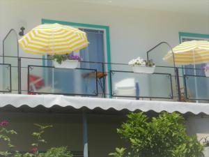 塞博登Villa Rauter的阳台上的三把遮阳伞,带花盆