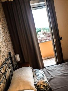 PianfeiACERO ROSSO的卧室在窗户前配有一张床