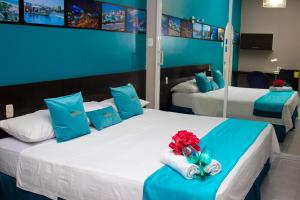 瓜亚基尔SUITES FullHouse的一间卧室配有两张蓝色和白色的床
