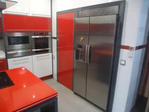 阿尔玛格鲁CASA RURAL LA SUITE DE ALMAGRO的厨房配有不锈钢冰箱和红色橱柜