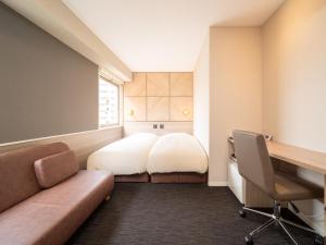鸟取市鸟取站前超级酒店的小房间设有一张床、一张桌子和一把椅子