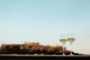 雅典360度流行艺术酒店的享有美景的桌子上放着两杯葡萄酒