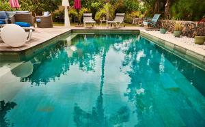 拉萨尔勒班La Villa de la Plage的庭院里的一个蓝色海水游泳池