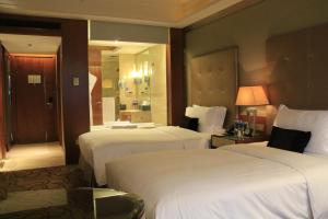 哈尔滨哈尔滨索菲特大酒店的酒店客房,设有两张床和镜子