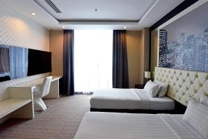怡保Jindagu Hotel Ipoh的酒店客房设有两张床和电视。
