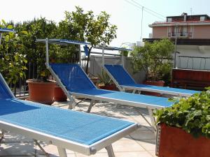 切塞纳蒂科Hotel Metron的坐在屋顶上的一排蓝色椅子