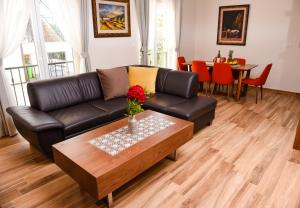 比耶拉Apartments Balbo的客厅配有黑色真皮沙发和咖啡桌