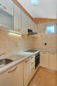 扎斯特拉齐塞Apartments Rubin的厨房配有白色橱柜和水槽