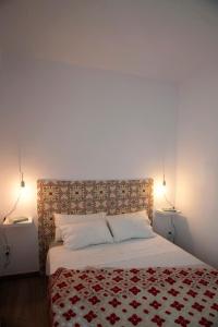 巴拉格尔Portolà, 1 apartament的一间卧室配有一张带红白毯子的床