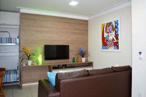马塞约Sun Paradise - JTR的带沙发和平面电视的客厅
