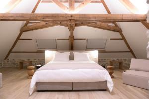 米洛Couvent de la Salette & Spa的卧室配有白色的床和沙发