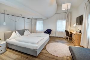 滨湖采尔Hotel Steinerwirt1493的卧室配有一张白色大床和一张书桌