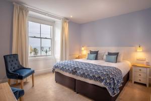 马拉扎恩马拉宰恩酒店的卧室配有床、椅子和窗户。