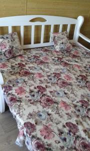 敖德萨Apartment Moe More的一张带花卉棉被和两个枕头的床
