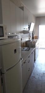 敖德萨Apartment Moe More的厨房配有白色橱柜和白色冰箱。