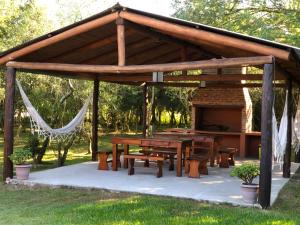 科洛尼亚卡洛斯佩莱格里尼Posada Che Teindy的公园内带野餐桌的木制凉亭