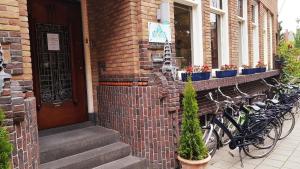 阿姆斯特丹德贝兹提精品胶囊酒店的停在砖砌建筑旁边的一群自行车