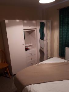 Belcoo3 MacNean Park的一间卧室配有一张床、梳妆台和衣柜。