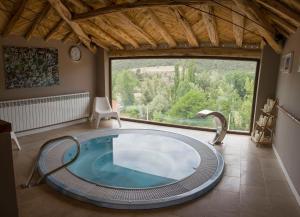 Corduente塞克斯玛德尔萨宾纳乡村度假屋的带大窗户的客房内的热水浴池