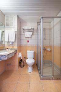 阿拉尼亚Alanya Beach Hotel的一间带卫生间和玻璃淋浴间的浴室