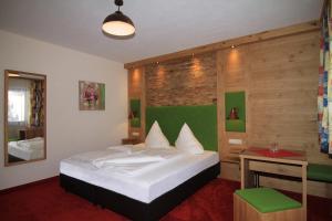 伊施格尔加尼普德拉酒店的一间卧室设有一张床和木墙