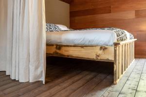 Kloosterzandebnb De Loft的木墙客房的一张床位