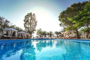 里科索翁萨梅瑞酒店的一个带椅子和遮阳伞的大型游泳池